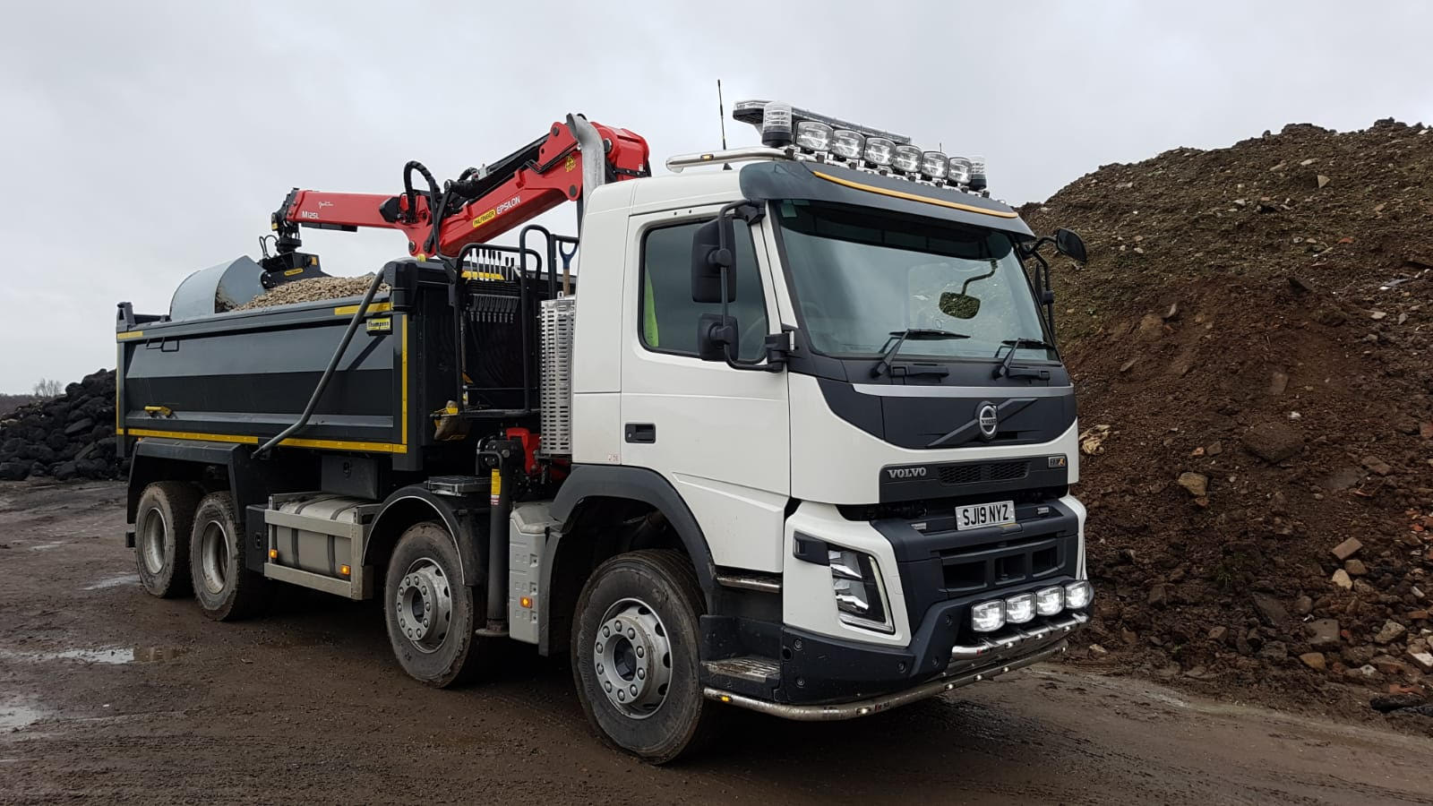 Side view of a Volvo grab wagon on site